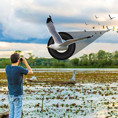 Photographer capturing a bird flying over a wetland.